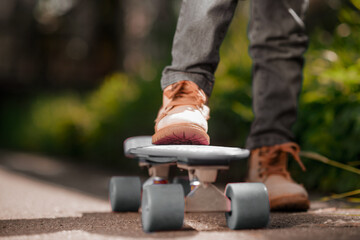 Close up picture of a kids hand holding a skateboard