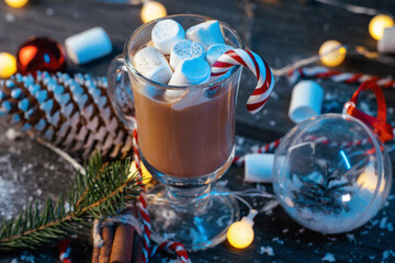 Hot cocoa with marshmallows and cinnamon on a wooden blue table close-up