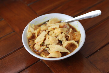 a close up of a ready-to-serve bowl of chicken porridge