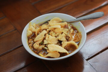 a close up of a ready-to-serve bowl of chicken porridge