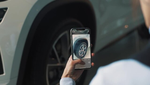 close-up of a smartphone screen removing a new wheel on a car