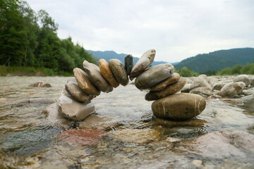 bridge with some grey stones in natural river - 549986347