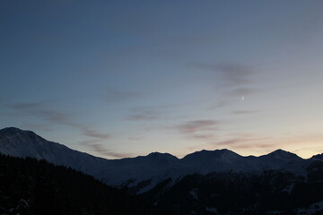 Silhouetted Swiss alps at Twilight. Alpine landscape wallpaper, background or screensaver with copy space (Verbier, Valais, Switzerland)