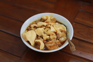 a close up of a ready-to-serve bowl of chicken porridge