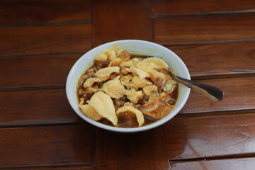 a close up of a ready-to-serve bowl of chicken porridge