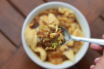 a close up of a ready-to-serve bowl of chicken porridge