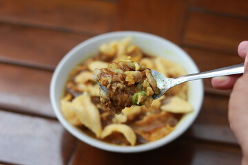 a close up of a ready-to-serve bowl of chicken porridge