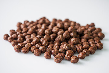 sweet crunchy chocolate children's breakfast chocolate balls on a white background