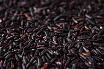 raw fresh black rice on a white background