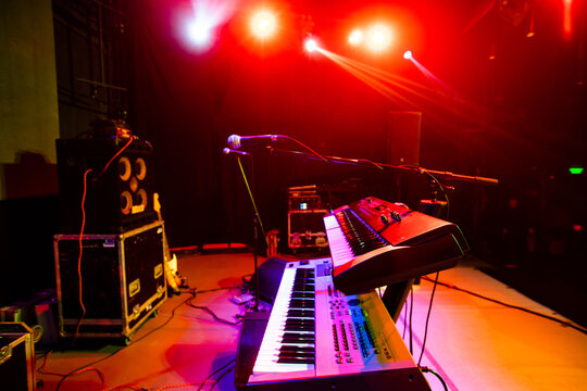 Closeup of synthesizer and mirophone on concert stage