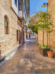 Fototapeta na wymiar Old narrow cozy street in the old city of Kaleiçi in Antalya