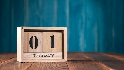 January First wooden vintage calendar on dark blue background.