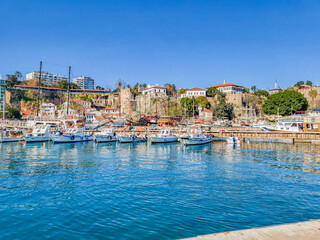 View of the old city marina or sea harbor with moored yachts against the backdrop of the old city Kaleiçi in Antalya