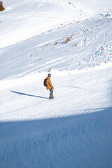 Male snowboarder on top of mountain in Austria with equipment. High quality image of snowboarding man on snowy mountain.