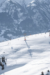 High quality photos of cable car on Austrian mountain. Images of ski slopes with gondola with white snow. 