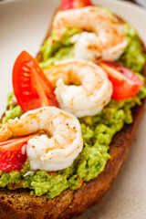 delicious Italian bruschetta with shrimps on a gray stone background