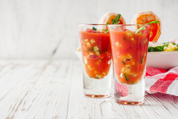 delicious summer gazpacho cocktail on a white wooden rustic background