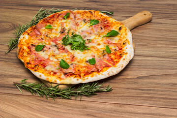 Italian pizza Capricciosa  with cheese, tomato sauce and basil