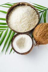 Fototapeta na wymiar fresh natural coconut and shavings dried flakes on white acrylic background