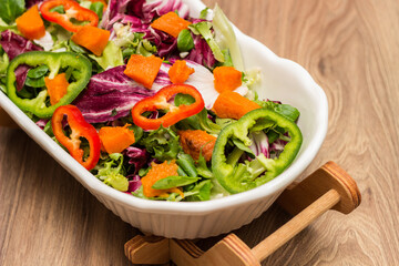 Bowl of freshly salad with pumpkin