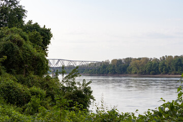 Bridge over river with trees and greenery