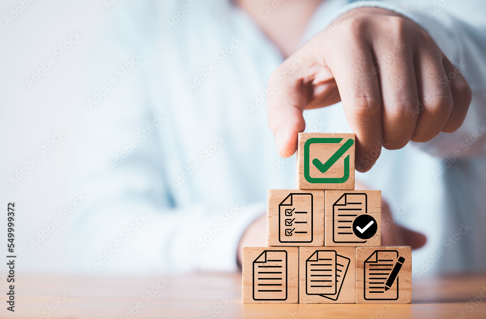 Poster Businessman stacking of document and correct sign mark for document approve , project acceptance and quality assurance concept.