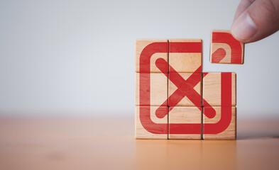 Hand assembly red tick mark which print screen on wooden cube block t , Approve and reject business...