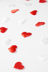 Red and white silk hearts isolated on white background. Valentine's day or Wedding romantic concept, top view, copy space, flat lay