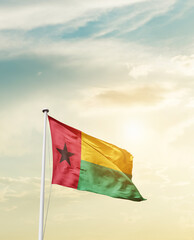 Waving Flag of Guinea-Bissau with beautiful Sky. 