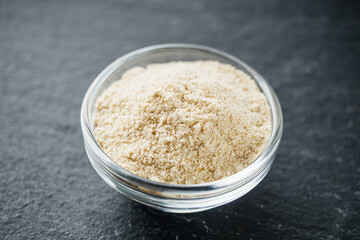 asafoetida aromatic powder on a black stone background