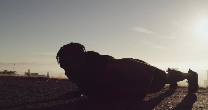 Silhouette, exercise and man doing pushup outdoor, fitness and wellness for health and training. Focus, young male and healthy athlete in nature, cardio and practice for motivation, strong or balance