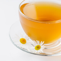 aromatic hot chamomile tea on a white background