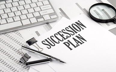 SUCCESSION PLAN text on paper with chart and keyboard, business concept