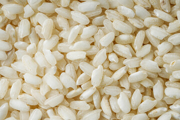 arborio rice for risotto on a white acrylic background