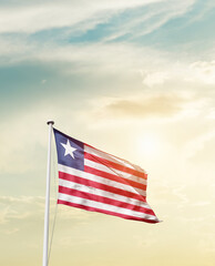 Waving Flag of Liberia with beautiful Sky.