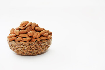 Fototapeta na wymiar small grains of natural dry brown almonds in a decorative plate