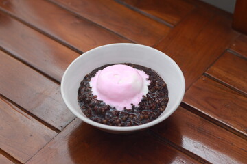 close up of a bowl of black sticky rice porridge