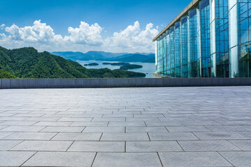 Empty square floor and glass walls with mountain background