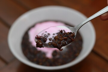 close up of a bowl of black sticky rice porridge