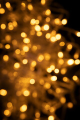Obraz premium Abstract background of blurred yellow lights for design. Lights bokeh dis focus. Christmas background, copy space