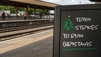 Train strikes to ruin Christmas! written on a sign at a train station