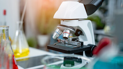 Laboratory research, microscope with lab glassware, science laboratory research and development concept.