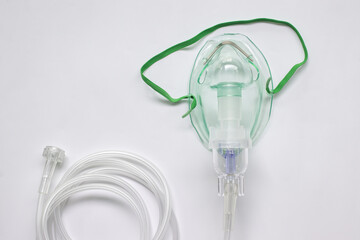 Oxygen mask with inhaler bulb on a white background.