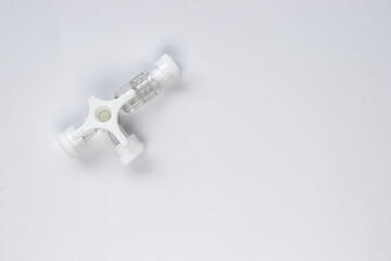 Three way stopcock with luer lock on white background.