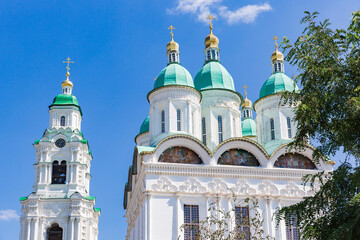 green-blue domes of Cathedral in Astrakhan kremlin through acacia branches