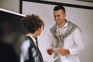 Man attentively listening to woman colleague in office