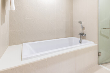 Fototapeta na wymiar White bathtub in modern bathroom interior design