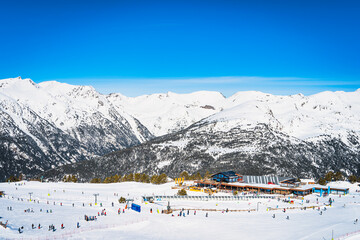 People, families, skiers and snowboarders relaxing and having fun in winter at Soldeu ski lifts...