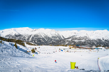 Family ski holiday, view on Soldeu ski lifts cross centre located in beautiful winter mountain range scenery, Grandvalira, Andorra, Pyrenees Mountains