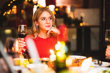 smiling woman holding glass of champagne in christmas day.